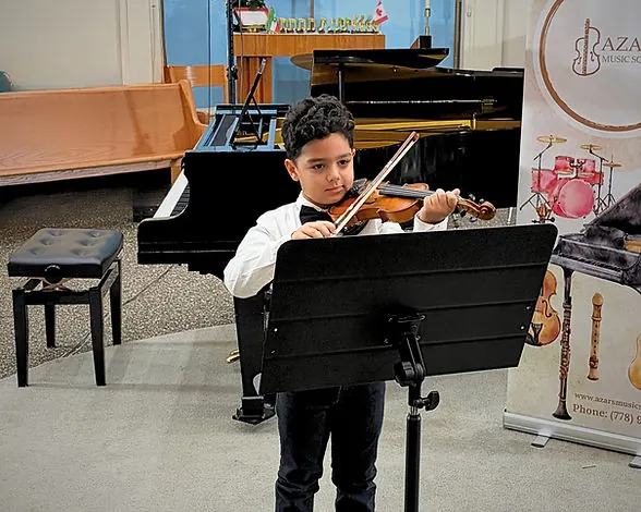 Young violin student performing at Azars' Music School